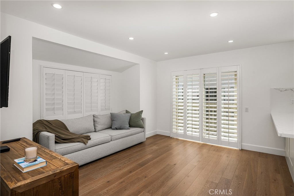 8 Moon Shadow, Unit 8 Irvine, CA 92603 - Photo 16 of 42 a living room with furniture and a wooden floor