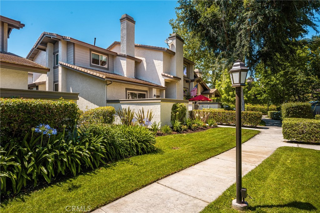8 Moon Shadow, Unit 8 Irvine, CA 92603 - Photo 2 of 42 a front view of a house with a yard
