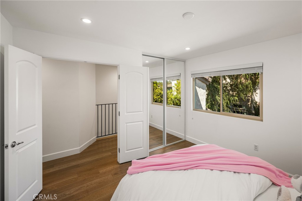 8 Moon Shadow, Unit 8 Irvine, CA 92603 - Photo 26 of 42 a bedroom with a bed and wooden floor