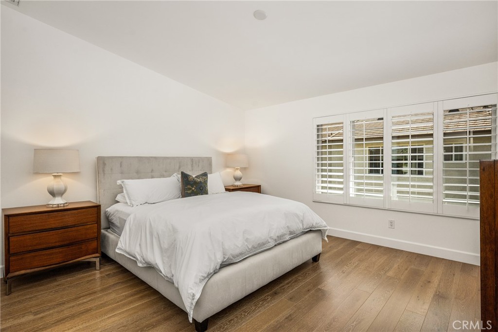 8 Moon Shadow, Unit 8 Irvine, CA 92603 - Photo 30 of 42 a bedroom with a bed and a large window