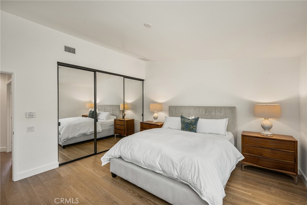 8 Moon Shadow, Unit 8 Irvine, CA 92603 - Photo 31 of 42 a bedroom with a bed and wooden floor