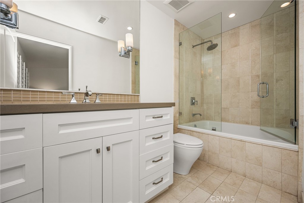 8 Moon Shadow, Unit 8 Irvine, CA 92603 - Photo 32 of 42 a bathroom with a double vanity sink toilet and shower