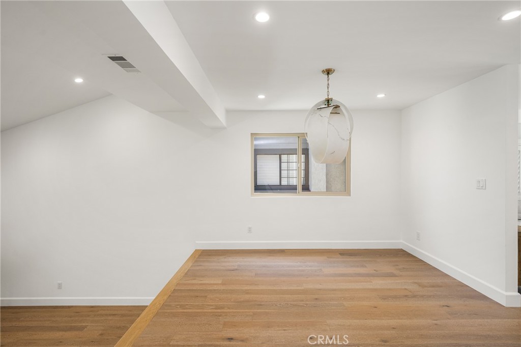 8 Moon Shadow, Unit 8 Irvine, CA 92603 - Photo 10 of 42 an empty room with wooden floor a ceiling fan and windows