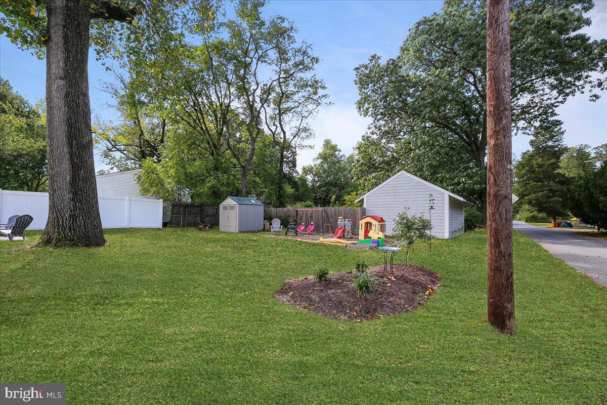 1602 Almonesson Road Woodbury, NJ 08096 - Photo 27 of 32 a front view of a house with a yard and a tree