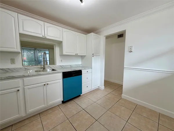 a kitchen with cabinets and window