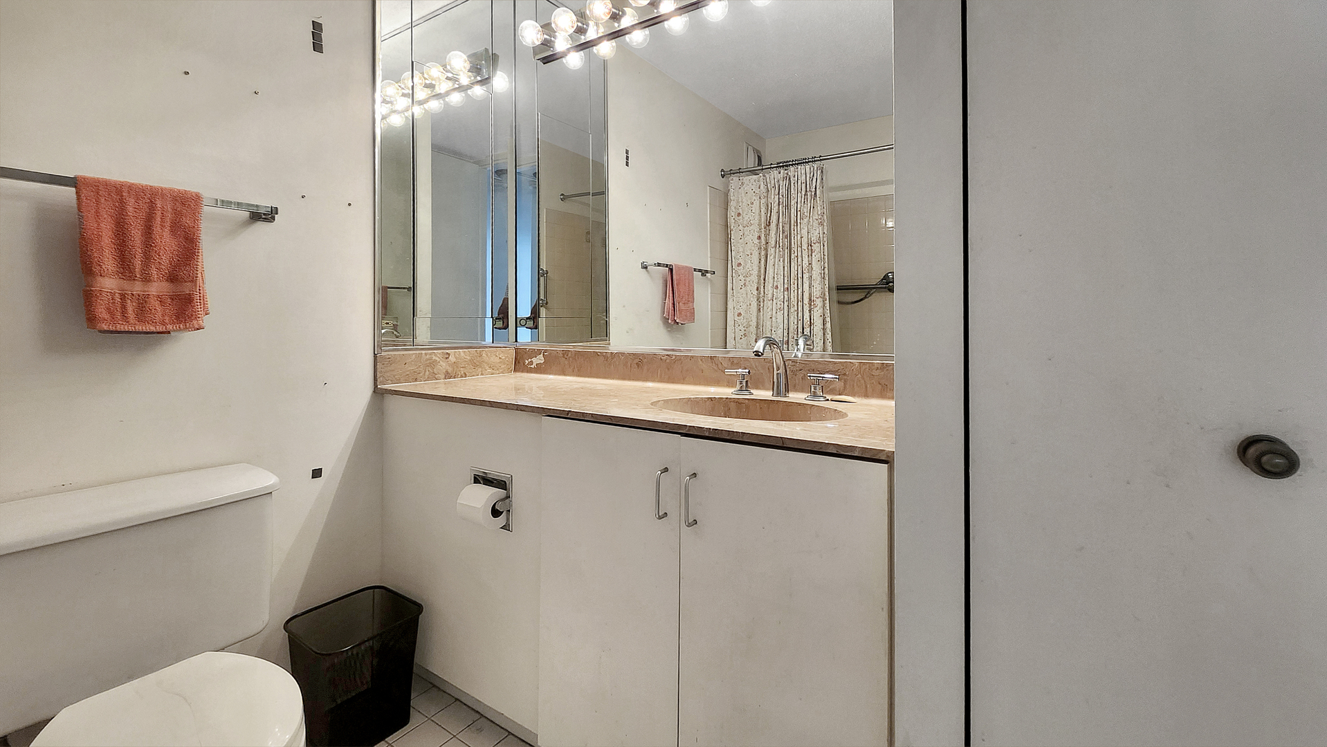 405 North Wabash Avenue, Unit 314 Chicago, IL 60611 - Photo 11 of 26 a bathroom with a sink a toilet a large mirror and shower