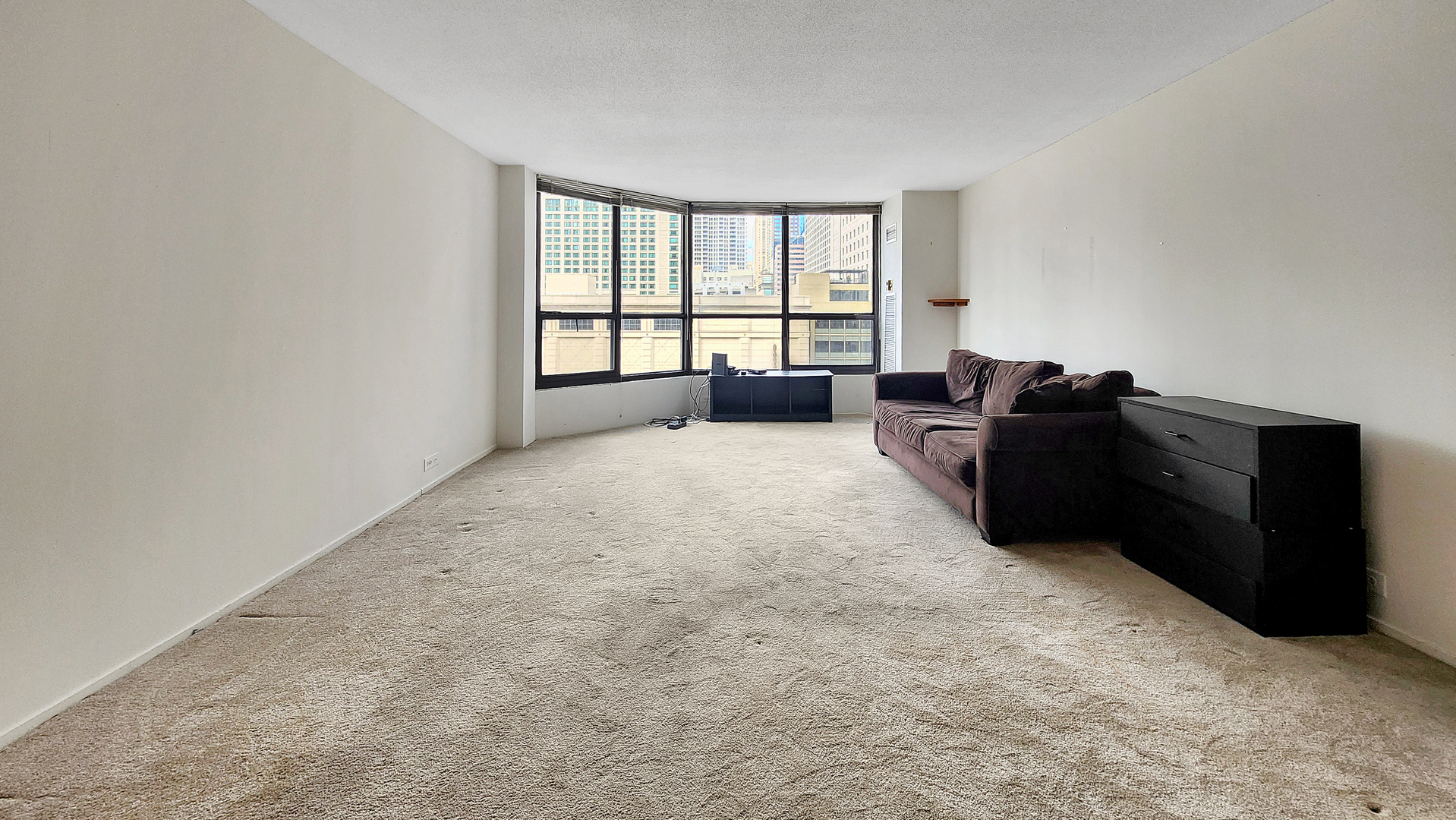 405 North Wabash Avenue, Unit 314 Chicago, IL 60611 - Photo 2 of 26 a large bed sitting in a room next to a window