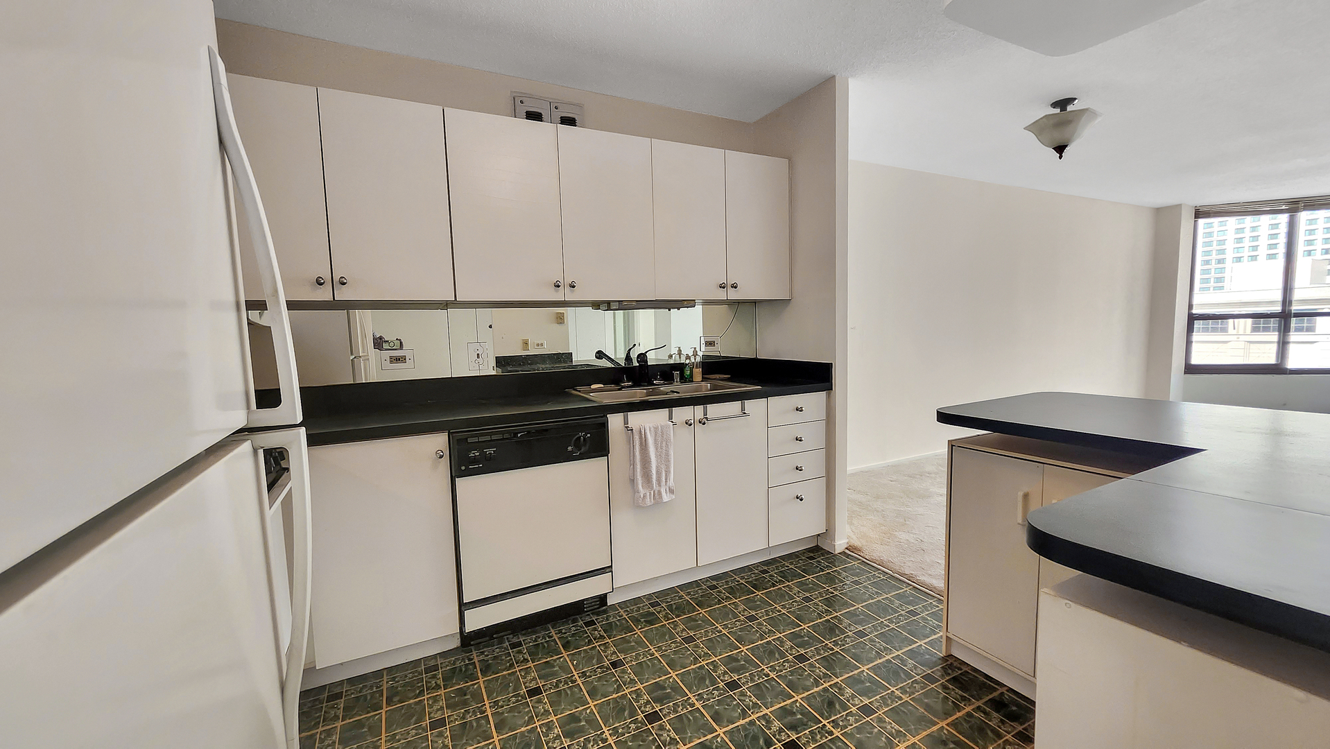 405 North Wabash Avenue, Unit 314 Chicago, IL 60611 - Photo 7 of 26 a kitchen with granite countertop white cabinets and white appliances