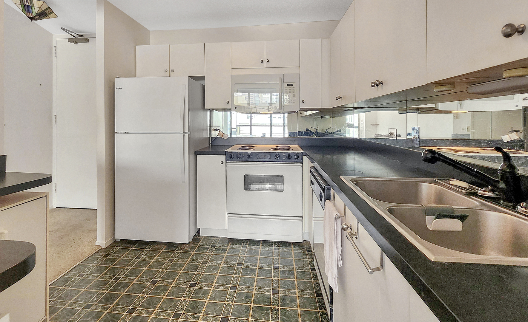 405 North Wabash Avenue, Unit 314 Chicago, IL 60611 - Photo 8 of 26 a kitchen with a refrigerator a sink and a stove