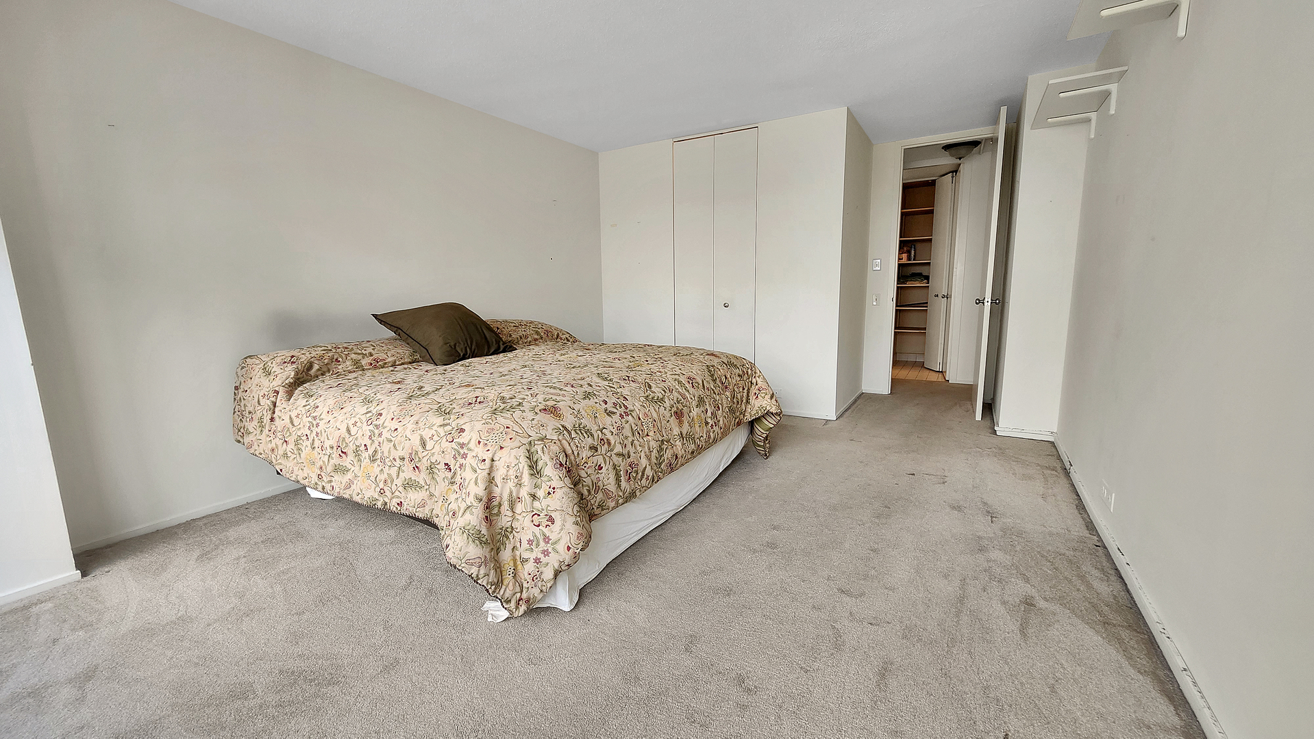 405 North Wabash Avenue, Unit 314 Chicago, IL 60611 - Photo 10 of 26 a bed sitting in a room next to a white cabinet