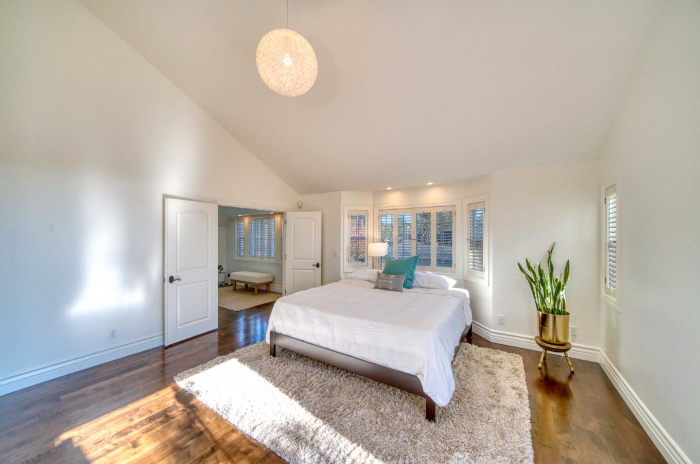 400 Seaview Drive Aptos, CA 95003 - Photo 31 of 58 a spacious bedroom with a bed table flowerpot and window