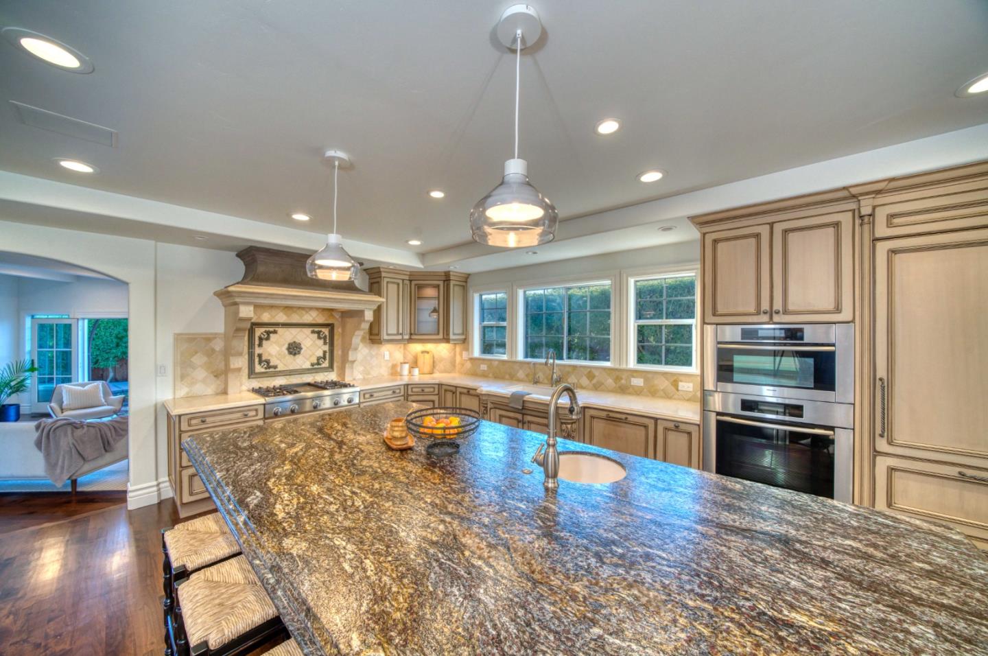 400 Seaview Drive Aptos, CA 95003 - Photo 9 of 58 a large kitchen with stainless steel appliances granite countertop a stove and cabinets with wooden floor