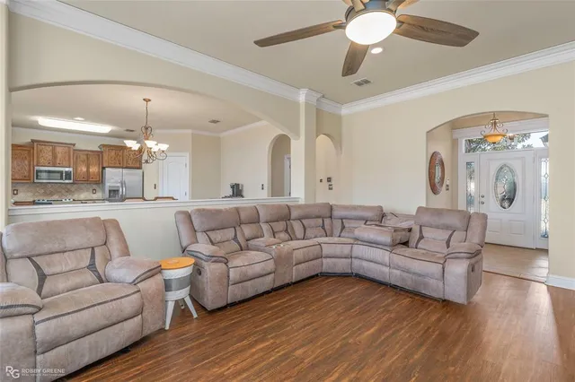 a living room with furniture and a chandelier