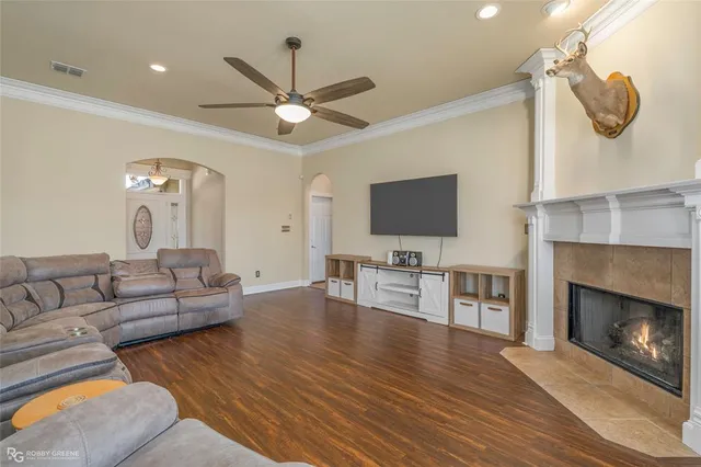 a living room with furniture a fireplace and a flat screen tv