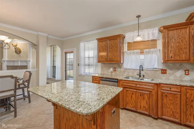 a kitchen with center island table and chairs