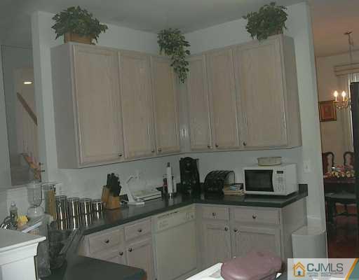 49 Timber Ridge Road North Brunswick, NJ 08902 - Photo 4 of 8 a kitchen with appliances cabinets and a counter top space