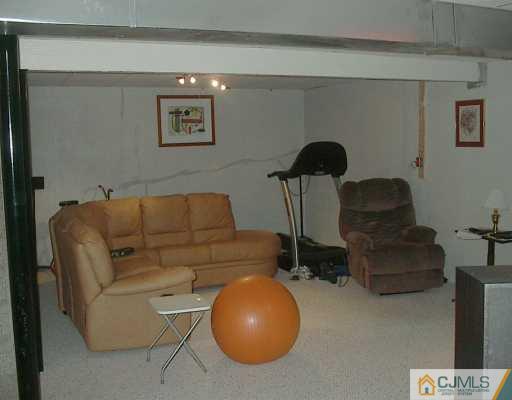 49 Timber Ridge Road North Brunswick, NJ 08902 - Photo 8 of 8 a living room with furniture and a lamp