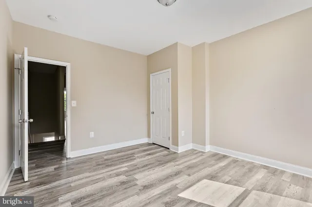 a view of a room with wooden floor