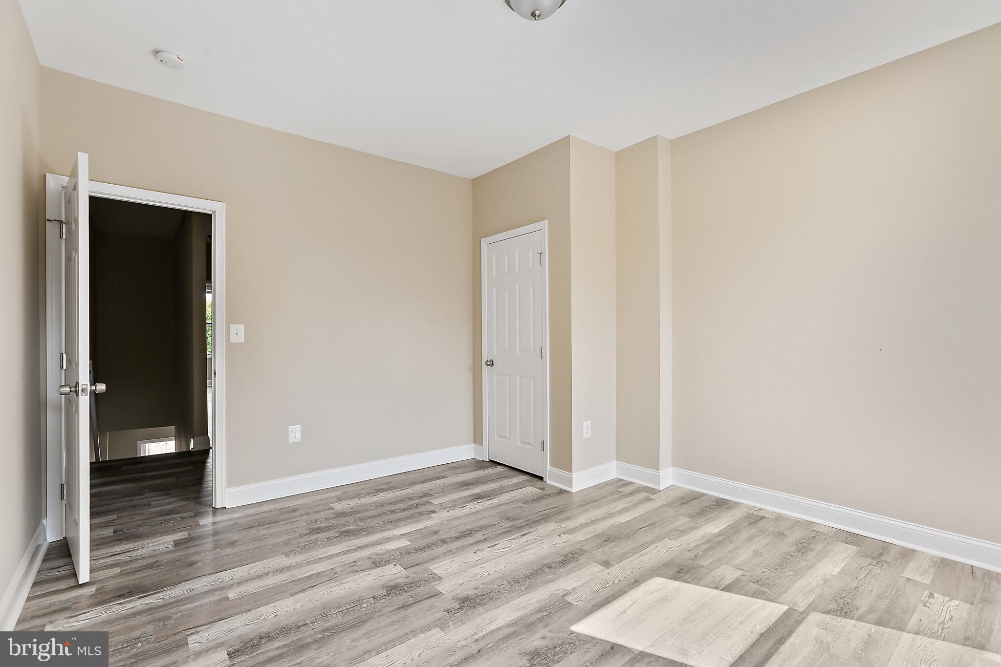 100 Collins Avenue Baltimore, MD 21229 - Photo 12 of 18 a view of a room with wooden floor