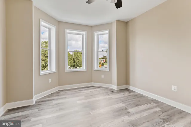 an empty room with windows and closet