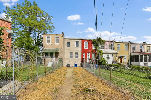 a front view of a house with a yard table and chairs