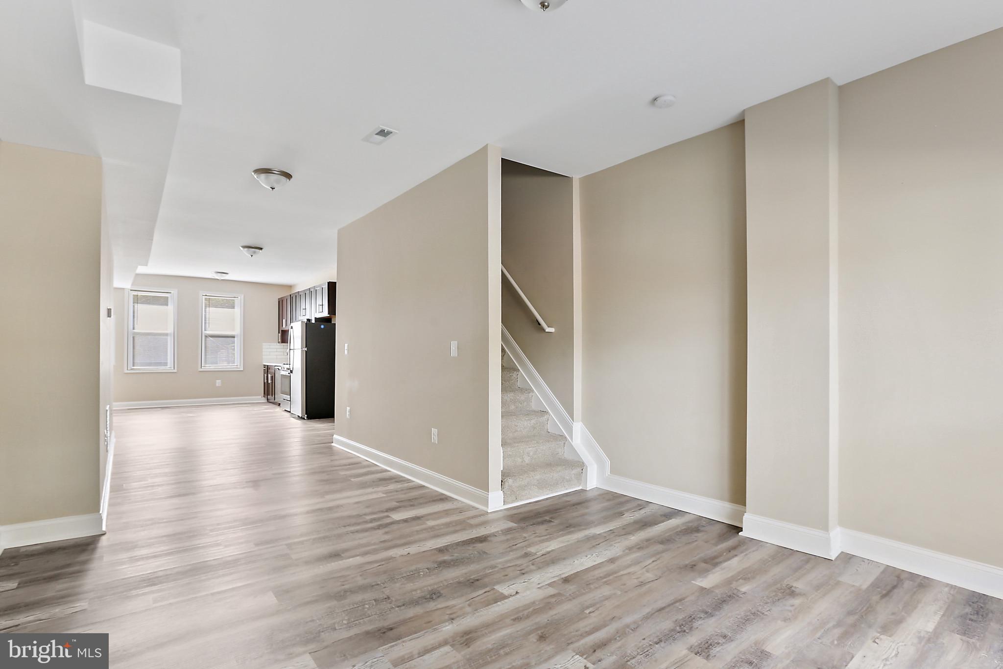 100 Collins Avenue Baltimore, MD 21229 - Photo 4 of 18 a view of a hallway with wooden floor and entryway