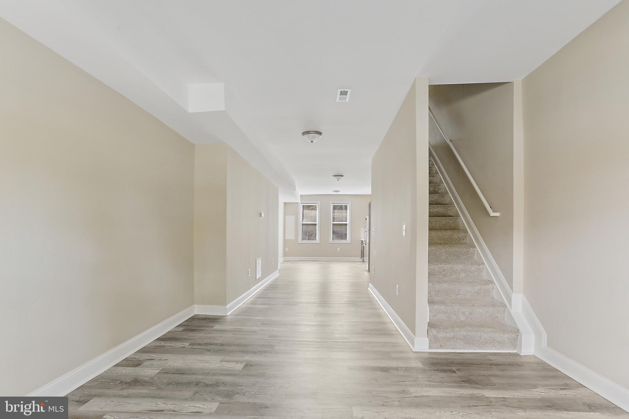 100 Collins Avenue Baltimore, MD 21229 - Photo 5 of 18 a view of a hallway with wooden floor and entryway