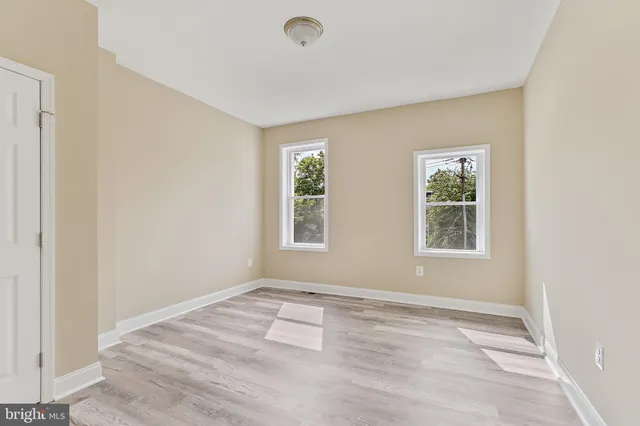 an empty room with windows and closet