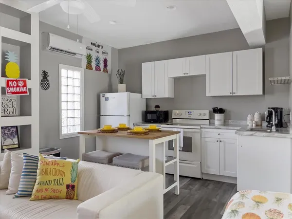 a picture of a room with a lot of white furniture