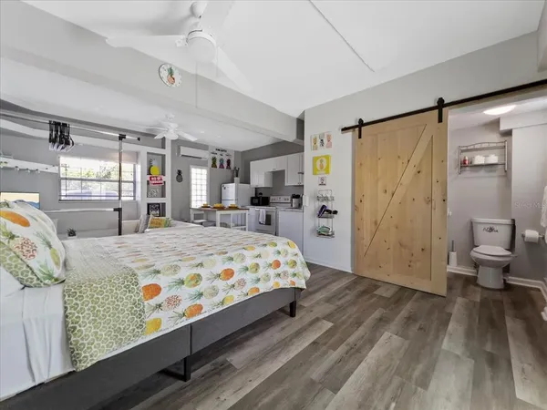 a front view of a house with a garden and trees