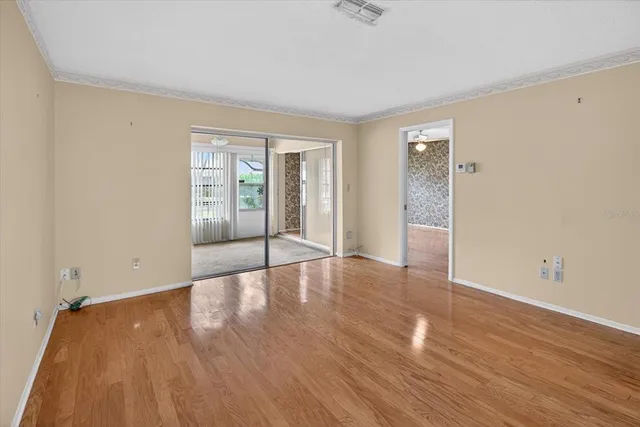 a view of empty room with wooden floor