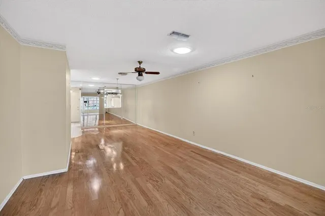 a kitchen with stainless steel appliances a sink a stove and white cabinets