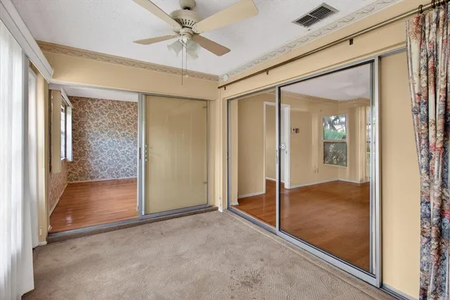 a view of a house with a big yard and potted plants