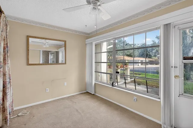 a view of a house next to a big yard and large trees