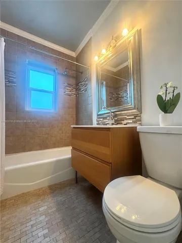 a view of an empty room with stairs and a chandelier