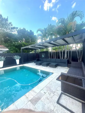 a view of a swimming pool with a patio