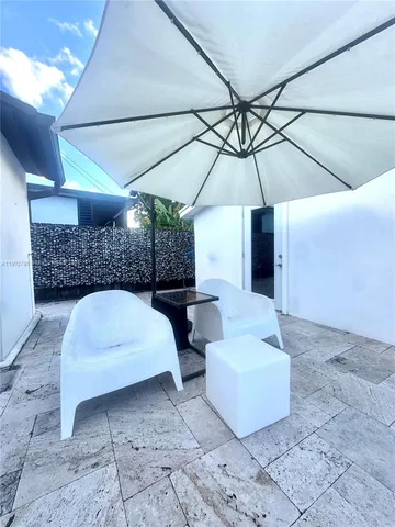 a large kitchen with stainless steel appliances wooden cabinets and a stove top oven