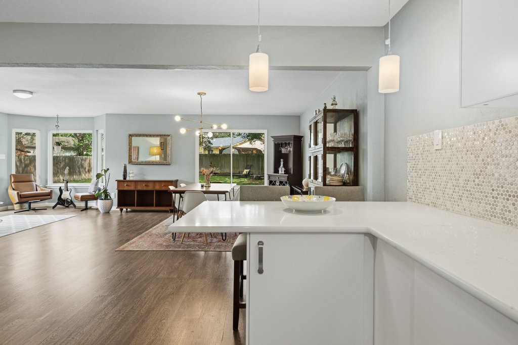 658 Mairo Street Austin, TX 78748 - Photo 14 of 40 An open concept living and dining area boasts rich hardwood floors and abundant natural light.