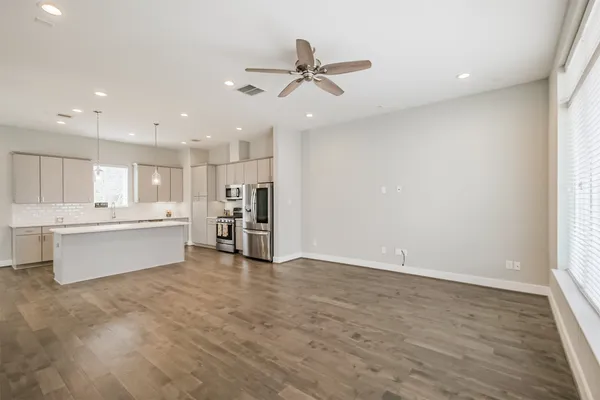 a view of a kitchen with a sink stainless steel appliances and window