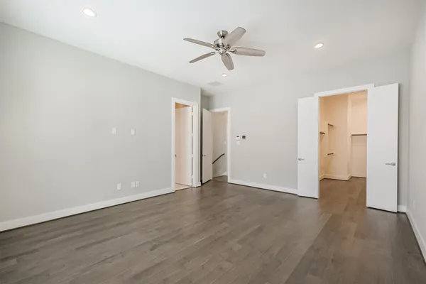 a view of an empty room with a ceiling fan