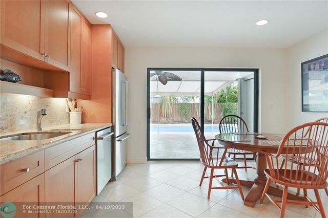a dining room with furniture and a large window