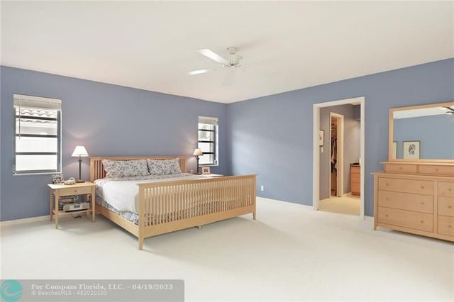 a spacious bedroom with a bed and a dresser