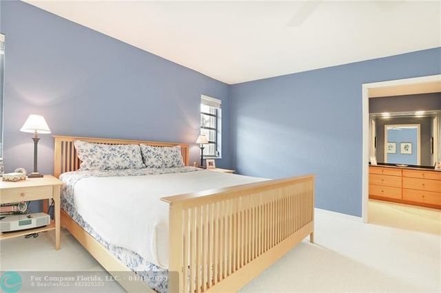 a bedroom with a bed and a lamp