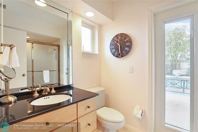 a bathroom with a toilet a sink and a mirror