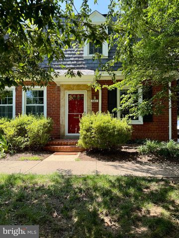 a view of a house with brick walls and a yard with plants