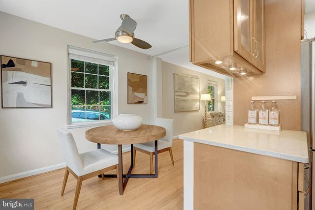 a view of hallway with livingroom and wooden floor