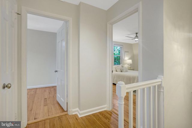a spacious bedroom with a bed and wooden floor