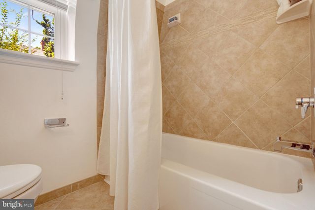 a living room with furniture a lamp and a table