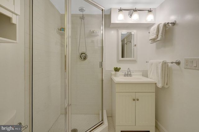 a view of a patio with table and chairs under an umbrella