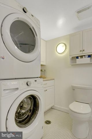a view of a swimming pool and lounge chairs in back yard